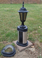 Short prototype boolard with lamp outside.